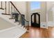 Stunning foyer with hardwood floors, staircase, and double doors with wrought iron accents at 3300 Greencastle Chase Ne, Marietta, GA 30062