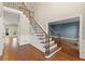 Elegant foyer with hardwood floors and staircase featuring iron spindles and natural lighting at 3300 Greencastle Chase Ne, Marietta, GA 30062
