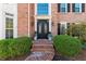 Stately brick home showcasing a grand front entrance with an elegant, arched, wrought-iron double door at 3300 Greencastle Chase Ne, Marietta, GA 30062