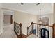 Hallway boasts a decorative railing, arched window, and chandelier, offering an inviting passage at 3300 Greencastle Chase Ne, Marietta, GA 30062