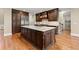 Open kitchen with dark wood island, stainless appliances, and breakfast bar is perfect for entertaining and gatherings at 3300 Greencastle Chase Ne, Marietta, GA 30062