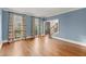 Bright living room with hardwood floors, staircase, and large windows with decorative curtains at 3300 Greencastle Chase Ne, Marietta, GA 30062