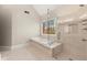 Bright main bathroom with a soaking tub, frameless shower, and large window with wooded views at 3300 Greencastle Chase Ne, Marietta, GA 30062