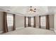 This main bedroom offers ample space, a ceiling fan, and multiple windows at 3300 Greencastle Chase Ne, Marietta, GA 30062