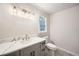 Updated bathroom features a gray vanity, quartz countertop, and stylish lighting at 6523 Walden Pond Rd, Stone Mountain, GA 30087