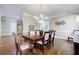 Formal dining room with hardwood floors, chandelier, and large table at 770 Westwind Ln, Alpharetta, GA 30005