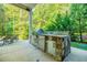 Outdoor kitchen with grill, sink, and refrigerator at 770 Westwind Ln, Alpharetta, GA 30005