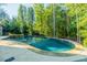 Inviting kidney-shaped pool surrounded by trees at 770 Westwind Ln, Alpharetta, GA 30005