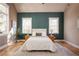 Spacious bedroom with teal shiplap accent wall and hardwood floors at 185 Marion # B, Atlanta, GA 30307