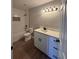 Updated bathroom with white subway tile, quartz vanity, and vinyl flooring at 2002 Country Park Se Dr, Smyrna, GA 30080