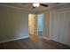 A well lit bedroom featuring a closet, neutral walls and wood floors at 2002 Country Park Se Dr, Smyrna, GA 30080