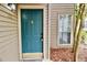 Close-up of the front door with a decorative knocker, set against the neutral siding and a small window at 2002 Country Park Se Dr, Smyrna, GA 30080