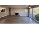 Living room with fireplace, wood-look floors, and lots of natural light at 2002 Country Park Se Dr, Smyrna, GA 30080