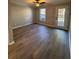 Spacious living room with wood-look floors and sliding glass doors at 2002 Country Park Se Dr, Smyrna, GA 30080