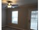 Bright living room features ceiling fan, ample natural light from windows and a glass door at 2002 Country Park Se Dr, Smyrna, GA 30080