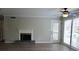 Bright living area featuring a fireplace and glass door at 2002 Country Park Se Dr, Smyrna, GA 30080