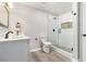 Bathroom with a glass enclosed shower, modern fixtures and gray wood-look floors at 2002 Country Se Dr, Smyrna, GA 30080