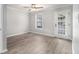 Bedroom featuring wood-look flooring, a ceiling fan, and a door leading to the outdoors at 2002 Country Se Dr, Smyrna, GA 30080