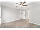 This bedroom features wood-look flooring, a ceiling fan, and white trim at 2002 Country Se Dr, Smyrna, GA 30080