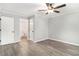 Bedroom featuring wood-look flooring, ceiling fan, and an ensuite bathroom at 2002 Country Se Dr, Smyrna, GA 30080