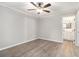 Bedroom with ceiling fan, wood-look flooring, neutral paint and an ensuite bathroom at 2002 Country Se Dr, Smyrna, GA 30080