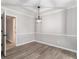 Elegant dining room with chair rail, modern light fixture, and wood-look flooring at 2002 Country Se Dr, Smyrna, GA 30080