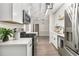 Bright kitchen showcasing stainless steel appliances, white cabinets, and durable wood-look flooring at 2002 Country Se Dr, Smyrna, GA 30080