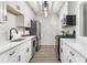 Modern galley kitchen featuring white cabinets, stainless steel appliances, and sleek countertops at 2002 Country Se Dr, Smyrna, GA 30080