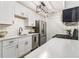 Modern kitchen featuring stainless steel appliances, quartz countertops, and a stylish black light fixture at 2002 Country Se Dr, Smyrna, GA 30080