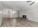 Open-concept living area featuring hardwood floors, a fireplace, and a view into the kitchen at 2002 Country Se Dr, Smyrna, GA 30080