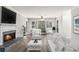 Bright living room with fireplace, ceiling fan, and natural light streaming through large windows at 2002 Country Se Dr, Smyrna, GA 30080