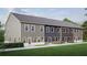 Rear view of townhouses showcasing gray, blue, and brown siding, and private backyard space at 3104 Marbella Cir # 2, Kennesaw, GA 30152