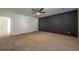 Large bedroom with dark accent wall and ceiling fan at 3276 Rollingbrook Way, Duluth, GA 30096