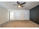 Bright bedroom featuring carpet, ceiling fan and multiple closets at 3276 Rollingbrook Way, Duluth, GA 30096