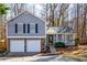 Gray house with white two-car garage and landscaped yard at 3276 Rollingbrook Way, Duluth, GA 30096