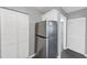 Stainless steel refrigerator in kitchen with white shaker cabinets and gray walls at 3488 Shepherds Path, Decatur, GA 30034