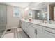 Spa-like bathroom with double vanity, walk-in shower, and grey tile floors at 1184 Warner Park Ct, Decatur, GA 30033