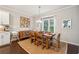 Bright dining room features a wood table, six chairs, and an area rug at 1184 Warner Park Ct, Decatur, GA 30033