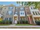 Three story townhouses with brick and stone exterior, landscaping and sidewalks at 1184 Warner Park Ct, Decatur, GA 30033