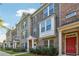 Brick townhouses with gray stone accents, landscaping, and red front doors at 1184 Warner Park Ct, Decatur, GA 30033