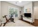 Home office with Peloton bike, TV, and work space at 1184 Warner Park Ct, Decatur, GA 30033