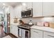 Modern kitchen features white cabinets, stainless steel appliances, and quartz countertops at 1184 Warner Park Ct, Decatur, GA 30033