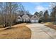 Brick home with a large driveway and mature trees at 1263 Irwin Lake Way, Marietta, GA 30064