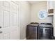 Convenient laundry room with washer, dryer, and built-in shelving at 1263 Irwin Lake Way, Marietta, GA 30064