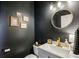 Stylish powder room with gold accents and dark walls at 1263 Irwin Lake Way, Marietta, GA 30064