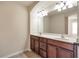 Double vanity bathroom with dark wood cabinets and large mirror at 2375 Morgan Farm Dr, Buford, GA 30519