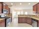 Open concept kitchen boasts granite countertops and stainless steel appliances at 2375 Morgan Farm Dr, Buford, GA 30519