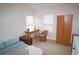 Well-lit bedroom with a desk and wicker chair at 2920 Fleetwood Dr, Cumming, GA 30041