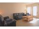 Bright living room featuring a comfy leather sofa and a coffee table at 2920 Fleetwood Dr, Cumming, GA 30041