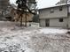 Snowy backyard with view of neighboring house and a small deck at 4906 Holbrook Cir, Duluth, GA 30096